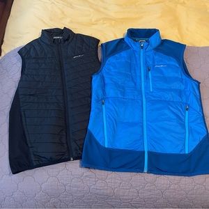 Two Eddie Bauer vests, blue and black, side medium.